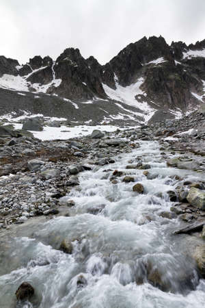 Mountain river on a grey cold dayの写真素材