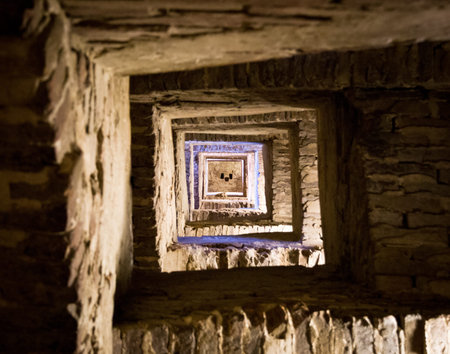 Looking up the stairs in the high Torre del Mangia in Siena, Italyの写真素材