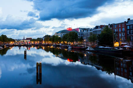 Early morning view on the river Amstel in Amsterdam, the Netherlands  Looking towards royal theater Carre and the skinny bridgeのeditorial素材