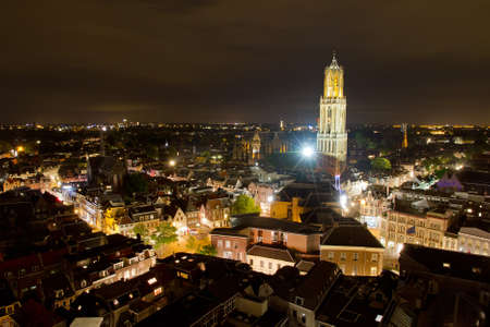 Cityscape of the city of Utrecht at night with the Dom cathedral lit by big lightsの写真素材