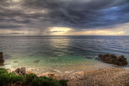 Storm at sea with a beautiful cloudscape seen from the shore  の写真素材