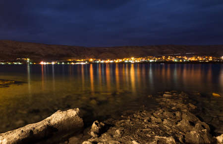 Evening view on the town of Pag in Croatia, on the other side of the bayの写真素材