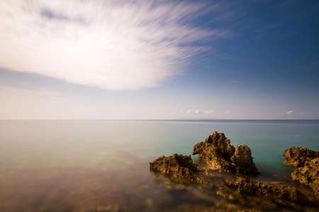 Looking over the ocean at the rocky Croatian coast, long exposure の写真素材