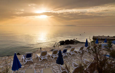Beautiful sunset on the rocky shores of the island Pag in Croatiaの写真素材