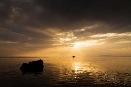 Small fishing boat on its way to nowhere in Croatiaの写真素材