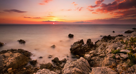 Beautiful colored sunset panorama at the rocky coast of Croatia