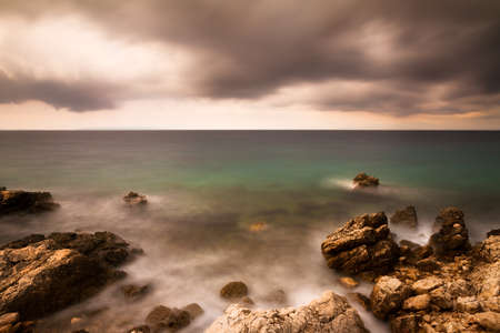 Dark image of a coastline in bad weather in Croatiaの写真素材