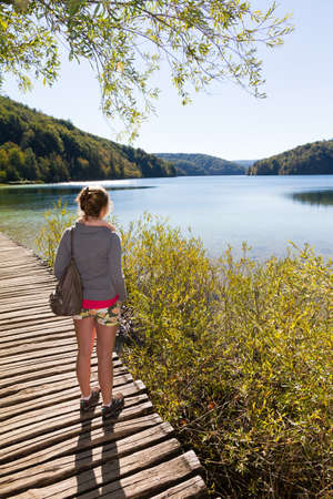 Woman looking over a lake in Croatiaの写真素材