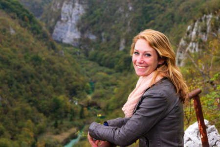 Beautiful young woman at a panorama viewing pointの写真素材
