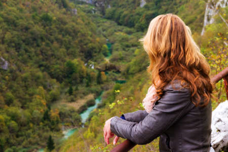 Beautiful young woman at a panorama viewing point の写真素材