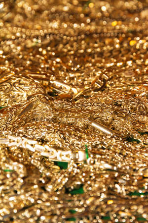 A lot of golden chains on a plateの写真素材