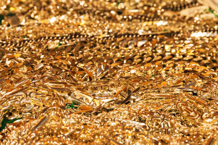 A lot of golden chains on a plateの写真素材