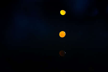 Drops of coffee falling towards water, high speedの写真素材