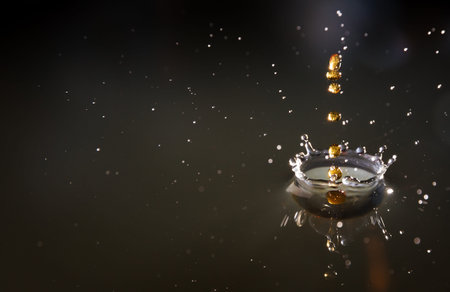 Drops of cola splashing in water, high speed