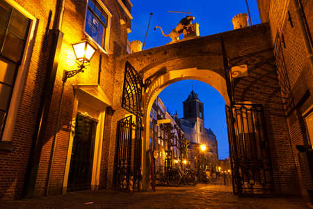 Burgsteeg in Leiden, the Netherlands  With the old gate to castle De Burcht and in the background the Hooglandse church at twilight のeditorial素材