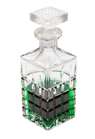 Crystal bottle with green liquid on a white backgroundの写真素材