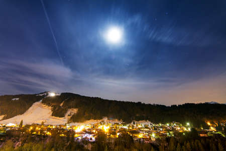 Beautiful winter nightscape with the moon over Morzine, Franceの写真素材