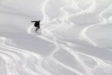 Awesome snowboarder is having fun in the backcountry powder of Les Portes du Soleil in Franceの写真素材