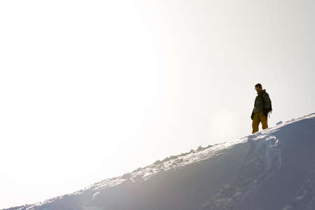Lonesome snowboarder ready to board in the backcountry in the Italian alpsの写真素材