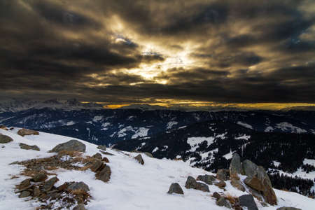 Dark and ominous sunset in the mountains in the European alpsの写真素材
