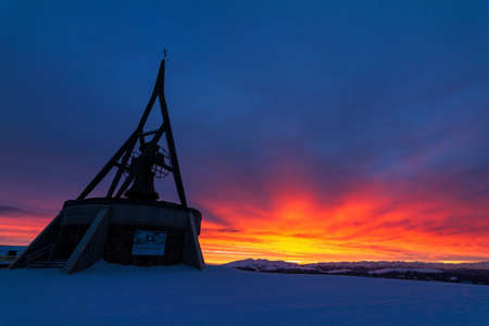 Beautiful sunset at the monument on top of the Kronplatz, Italyの写真素材