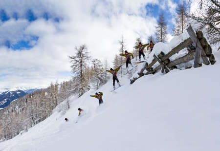 Awesome snowboarder jumps over an avalanche fenceの写真素材