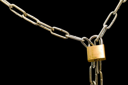 A chain and lock against a black computer screen background