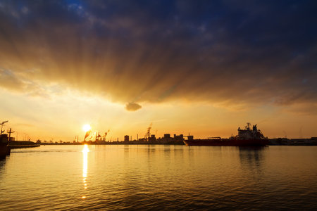 Sunset view of the heavy industry with smoking chimneys in IJmuiden, the Netherlandsの写真素材