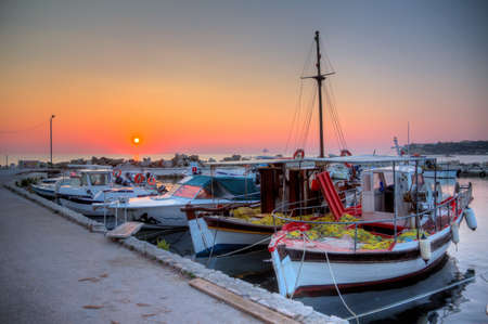 Beautiful sunrise in the little harbor of planos on the island of Zakynthos, Greeceの写真素材