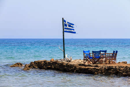 Greek flag at the end of a jetty on the island Zakynthos in summerの写真素材