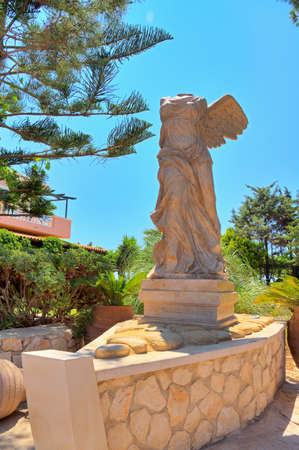Statue of an headless angel in a boat in Greeceの写真素材