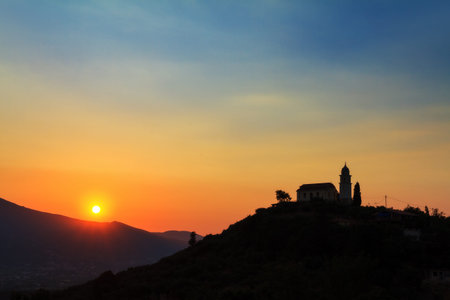 Beautiful sunset with a church on top of the hill on Zakynthos, Greece  