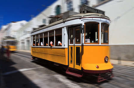 Beautiful traditional yellow tram in the streets of Lisbon, Portugal, in summerのeditorial素材
