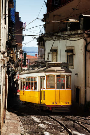Beautiful traditional yellow tram in the streets of Lisbon, Portugal, in summerのeditorial素材