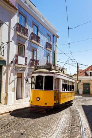 Beautiful traditional yellow tram in the streets of Lisbon, Portugal, in summerのeditorial素材