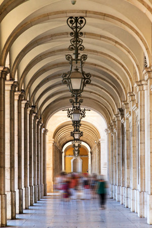Arched walkway between the columns on the commerce square in Lisbon, Portugal