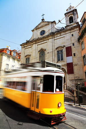 Beautiful traditional yellow tram in the streets of Lisbon, Portugal, in summerの写真素材