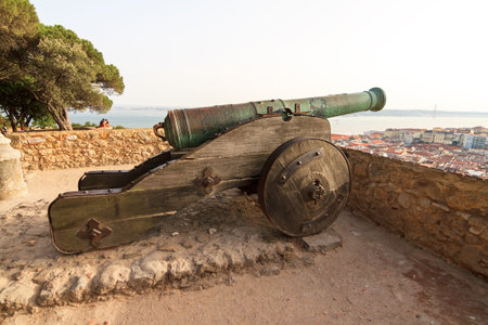 Big ancient cannon at castle Sao Jorge in Lisbon, Portugal, looking over the cityの写真素材