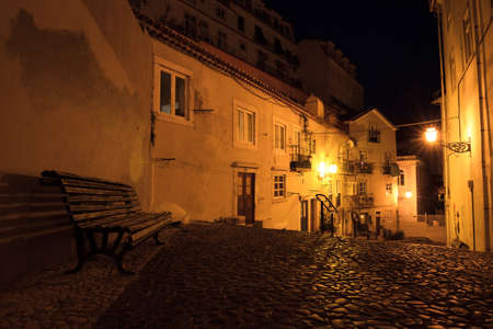 Typical urban scene in the narrow streets of Lisbon, Portugal, at nightの写真素材