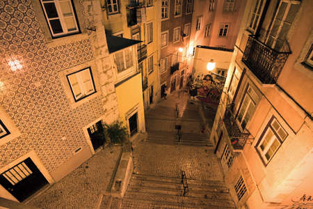 Typical urban scene in the narrow streets of Lisbon, Portugal, at nightの写真素材