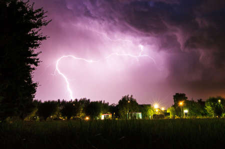 Beautiful big flash of lightning in the night sky over Baambrugge in the Netherlandsの写真素材