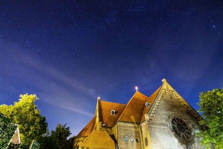 A church at night with lots of stars in Wageningen, The Netherlandsの写真素材