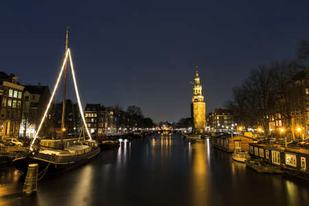 Night shot of the  Oudeschans  and the 16th century  Montelbaanstoren  in Amsterdam, The Netherlands のeditorial素材