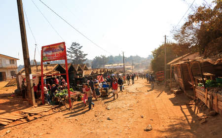 Typical street scene of a small village with people buying things on the street market in Ambatolampy, Madagascar, on September 5, 2013のeditorial素材