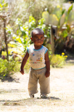 Young Malagasy boy walking outside in Andasibe, Madagascar, on September 12, 2013.のeditorial素材