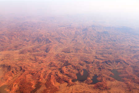 Aerial view of the deforestation of Madagascar, showing a red and empty landscapeの写真素材