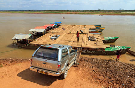 Tourists and their off road vehicle take the ferry during an excursion in Belo Tsiribihina, Madagascar, on September 14, 2013のeditorial素材