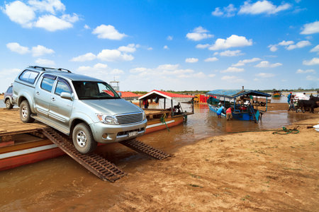 Tourists and their off road vehicle take the ferry during an excursion in Belo Tsiribihina, Madagascar, on September 14, 2013のeditorial素材