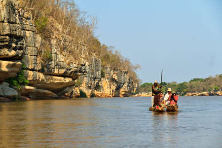 Tourists take an excursion on the Manambolo river with traditional boats in Belo Tsiribihina, Madagascar, on September 15, 2013のeditorial素材