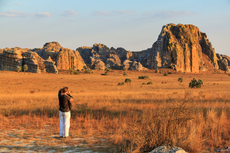 Tourist taking photos at sunset near the famous rock formation の写真素材